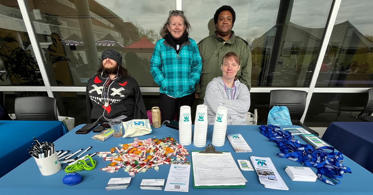 An image of Mental Health Partnerships participants and staff tabling